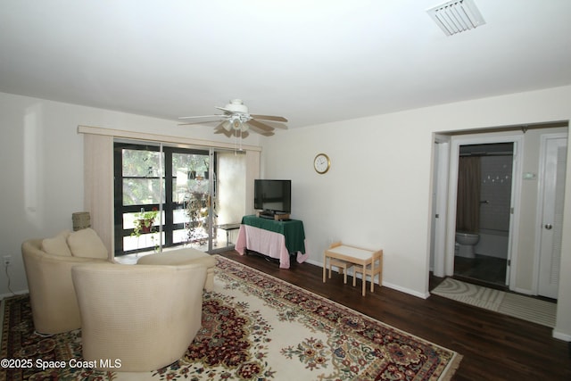 living room with ceiling fan and dark hardwood / wood-style flooring