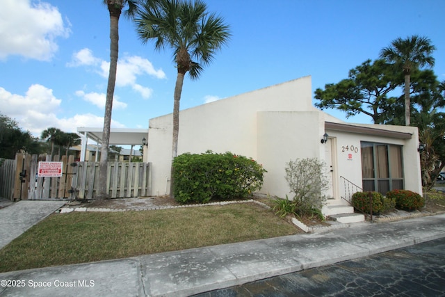 exterior space featuring a carport and a front lawn