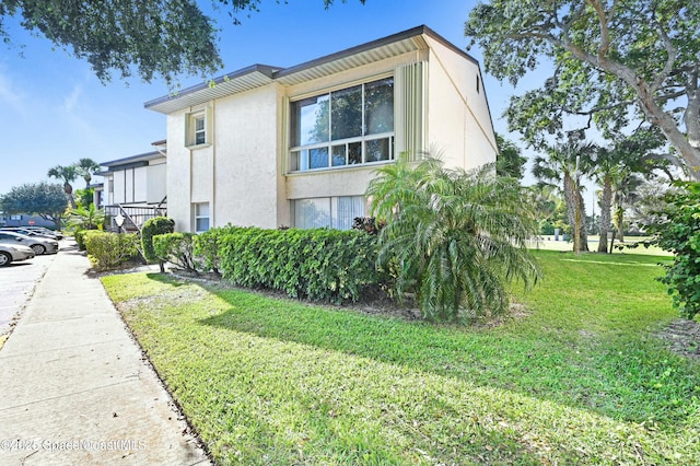 view of side of property with a yard