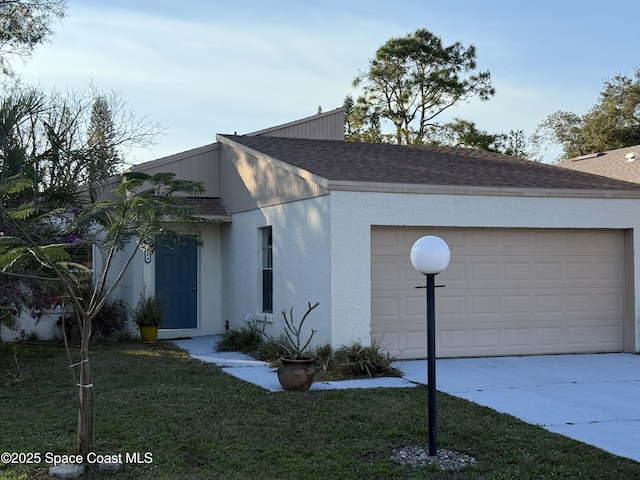 view of front of home with a garage and a front yard