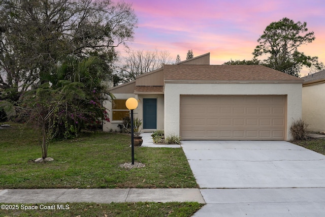 view of front of house with a garage and a lawn