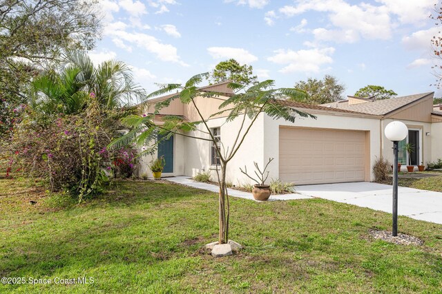 view of front of property with a garage and a front lawn