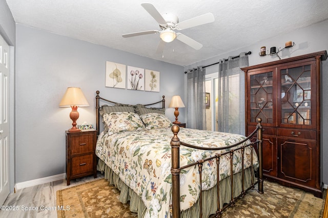 bedroom featuring ceiling fan and a textured ceiling