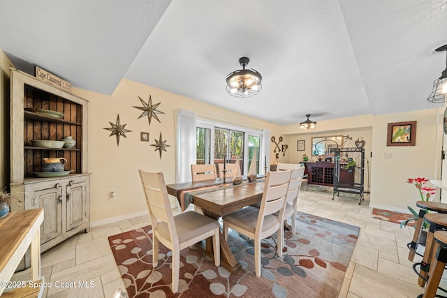 dining space with a textured ceiling