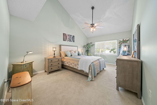 bedroom with ceiling fan, high vaulted ceiling, light colored carpet, and a textured ceiling