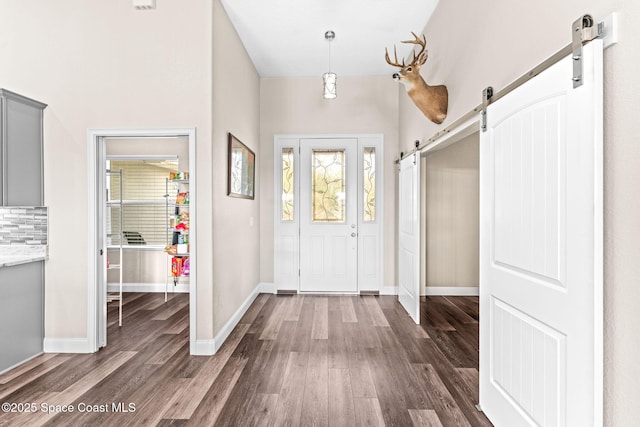 entryway featuring dark hardwood / wood-style flooring and a barn door