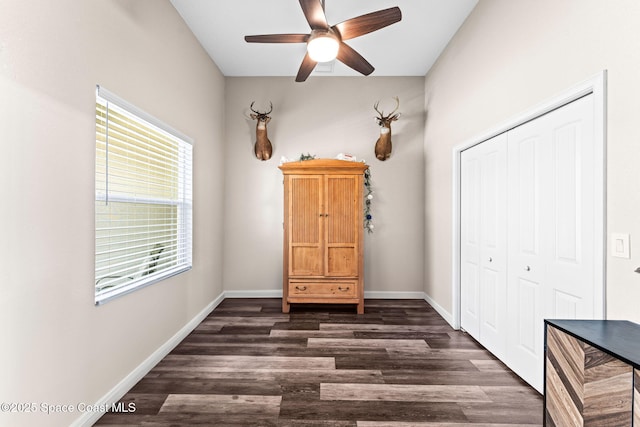 unfurnished bedroom featuring dark hardwood / wood-style floors, ceiling fan, and a closet