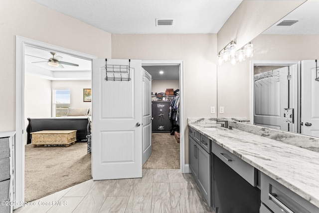 bathroom featuring ceiling fan and vanity