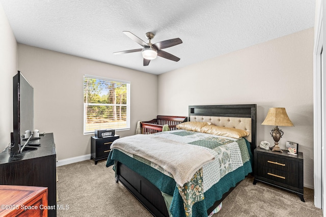 carpeted bedroom featuring ceiling fan and a textured ceiling