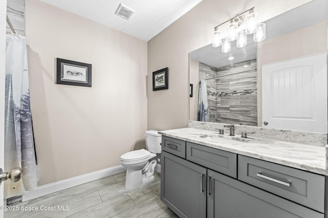 bathroom featuring walk in shower, vanity, and toilet