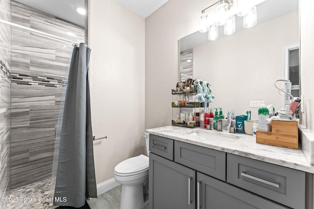 bathroom featuring vanity, toilet, and walk in shower