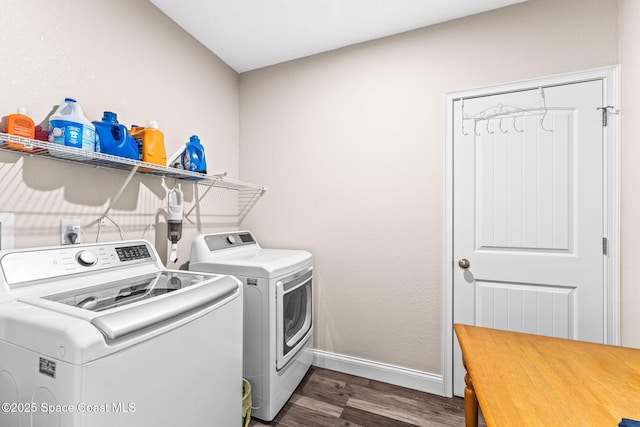 laundry room featuring separate washer and dryer and dark hardwood / wood-style flooring