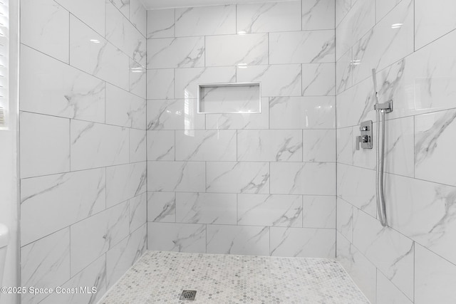 bathroom with tiled shower