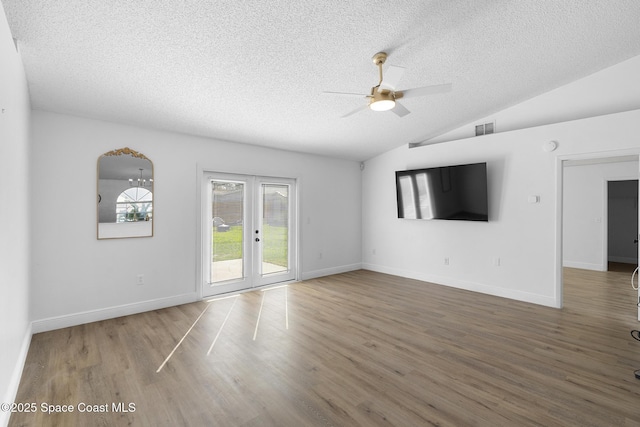 unfurnished living room with dark hardwood / wood-style floors, lofted ceiling, ceiling fan, a textured ceiling, and french doors