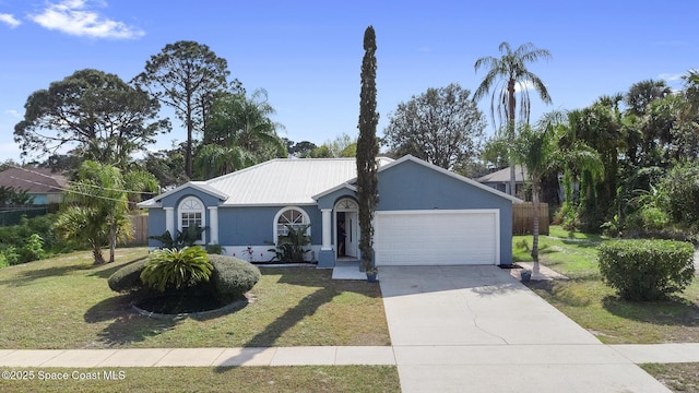 ranch-style home featuring a garage and a front yard