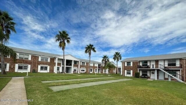 view of property's community with a lawn