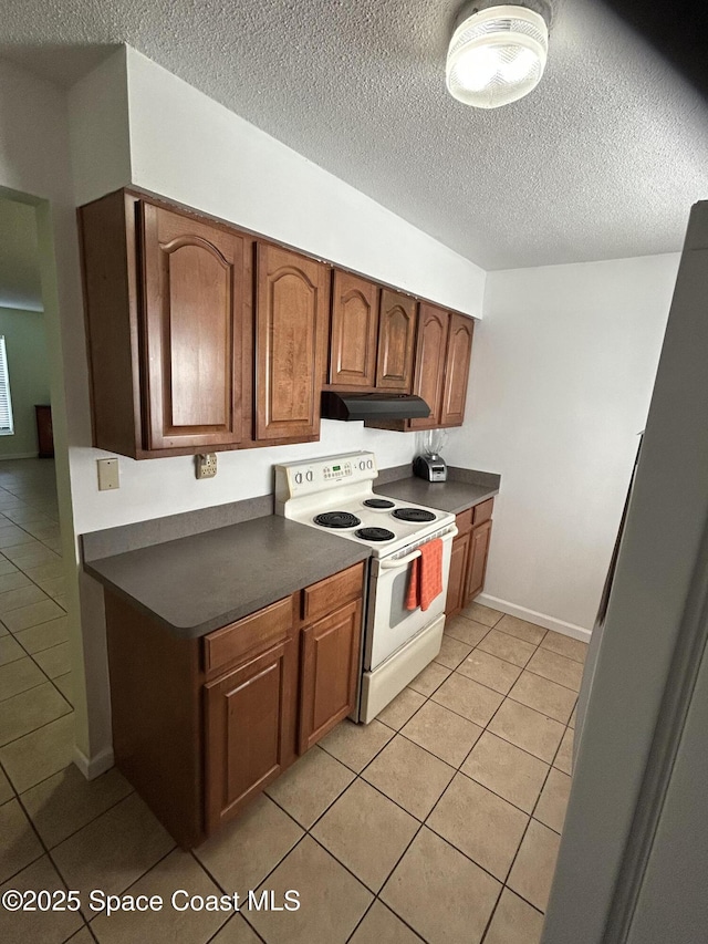 kitchen with electric stove, a textured ceiling, and light tile patterned flooring