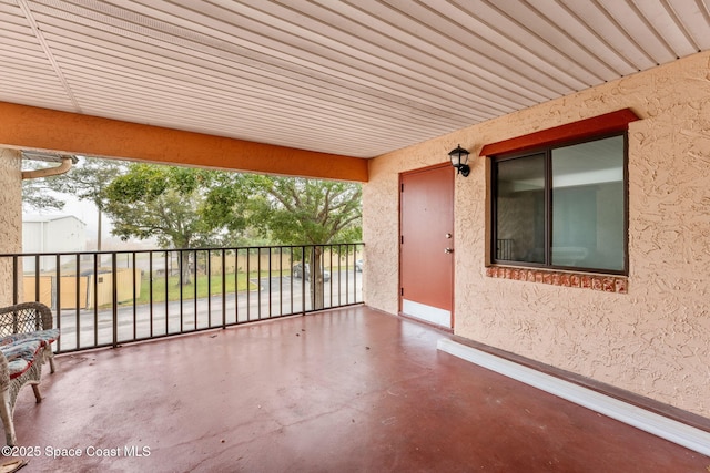 view of patio featuring a balcony