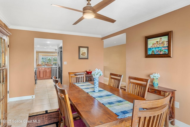 tiled dining area with ornamental molding and ceiling fan