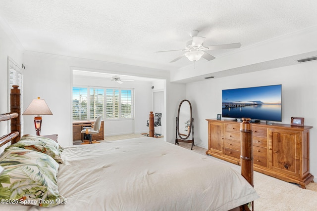 carpeted bedroom featuring ceiling fan, ornamental molding, and a textured ceiling