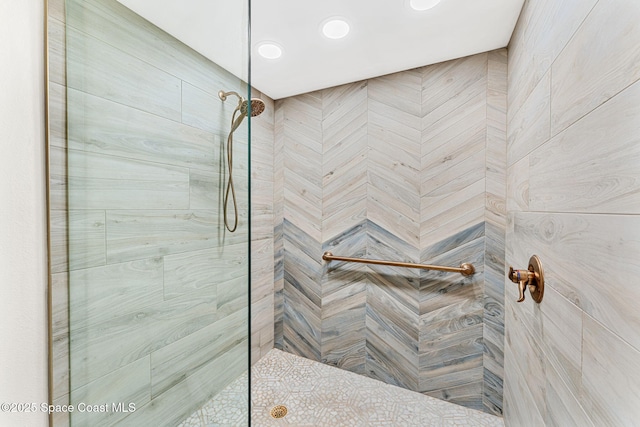 bathroom with a tile shower