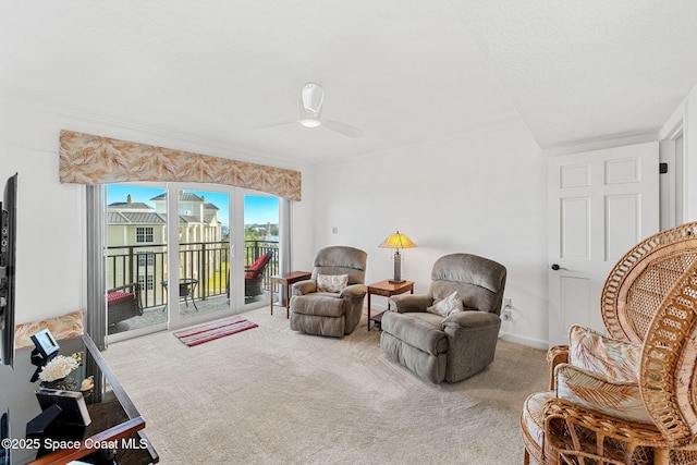 living area with carpet floors and ceiling fan