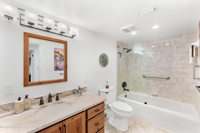 full bathroom featuring tiled shower / bath, vanity, tile patterned floors, and toilet