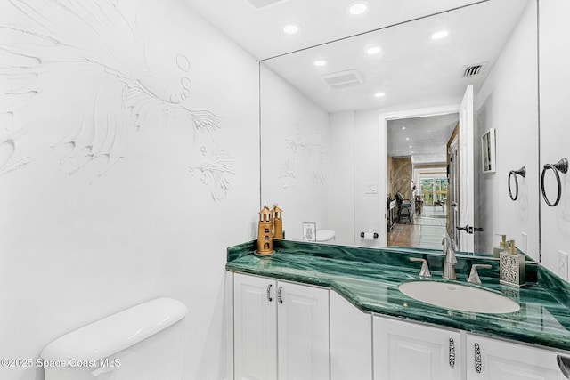 bathroom featuring vanity and toilet