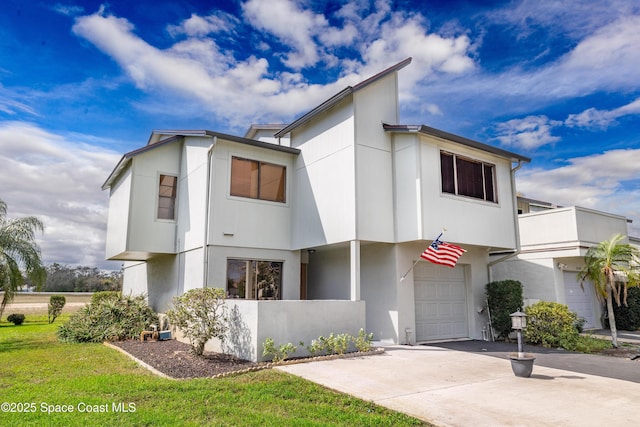 townhome / multi-family property with a balcony and a garage