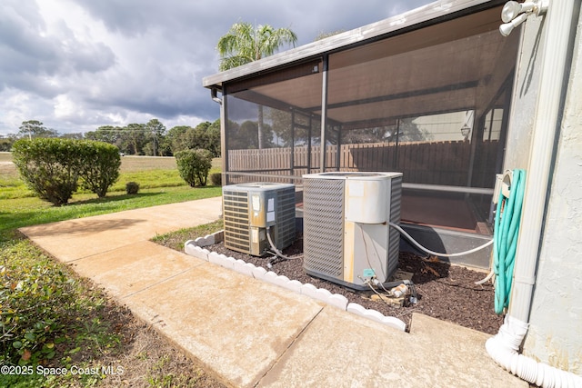 view of patio / terrace with cooling unit and a sunroom