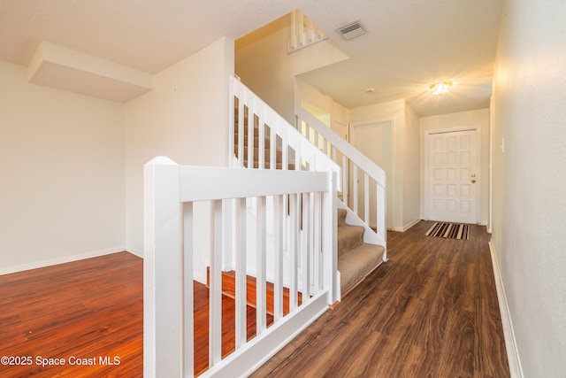 stairs with hardwood / wood-style floors