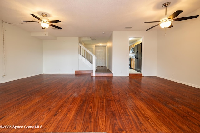 unfurnished living room featuring hardwood / wood-style flooring and ceiling fan