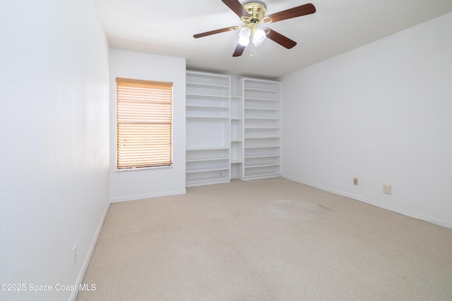 unfurnished bedroom with light colored carpet and ceiling fan