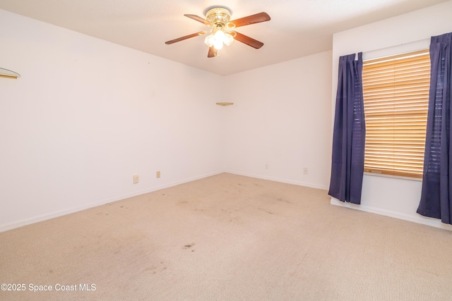 spare room with carpet flooring and ceiling fan