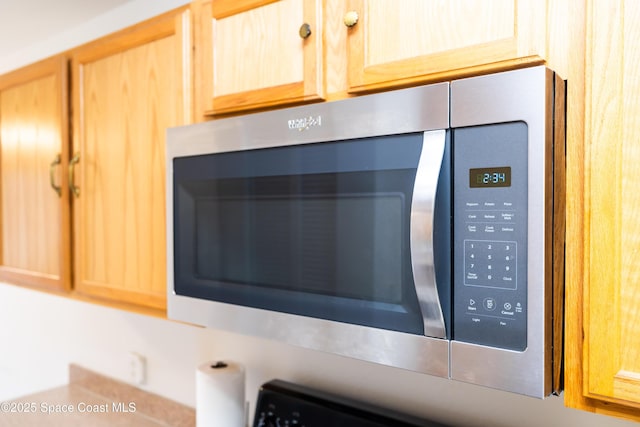 details with light brown cabinetry and mail boxes