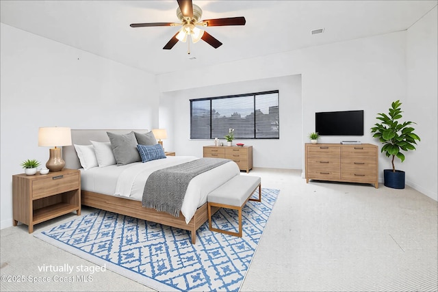 bedroom featuring light colored carpet and ceiling fan