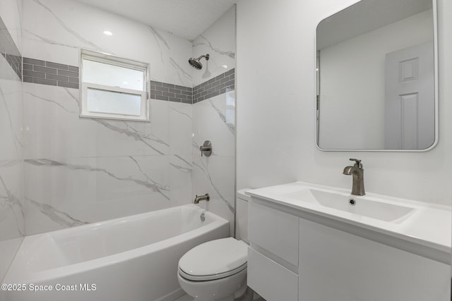 full bathroom featuring tiled shower / bath combo, vanity, and toilet