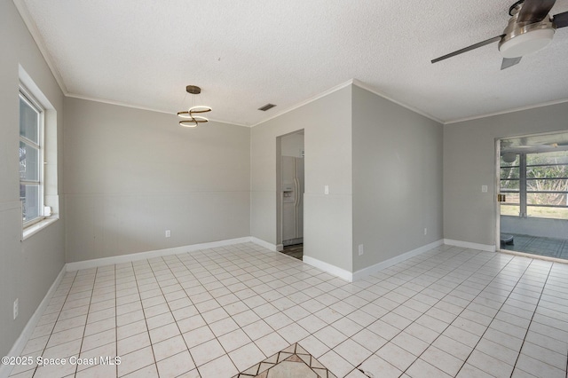 tiled empty room featuring ceiling fan, ornamental molding, and a textured ceiling