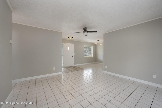 spare room with ornamental molding, light tile patterned floors, a textured ceiling, and ceiling fan