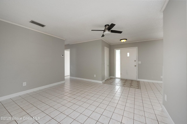 entryway with ceiling fan, ornamental molding, a textured ceiling, and light tile patterned flooring