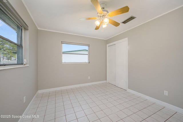 spare room with a wealth of natural light, ornamental molding, and ceiling fan