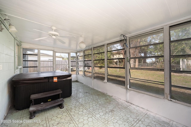 sunroom / solarium featuring ceiling fan