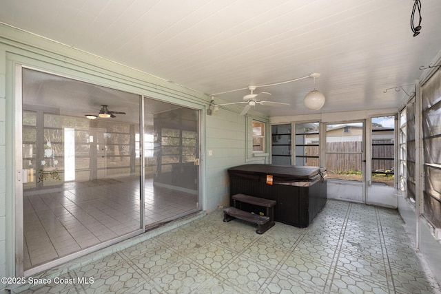 sunroom / solarium featuring ceiling fan