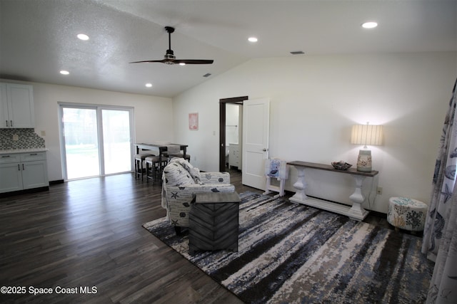 interior space featuring lofted ceiling, visible vents, dark wood-type flooring, and recessed lighting