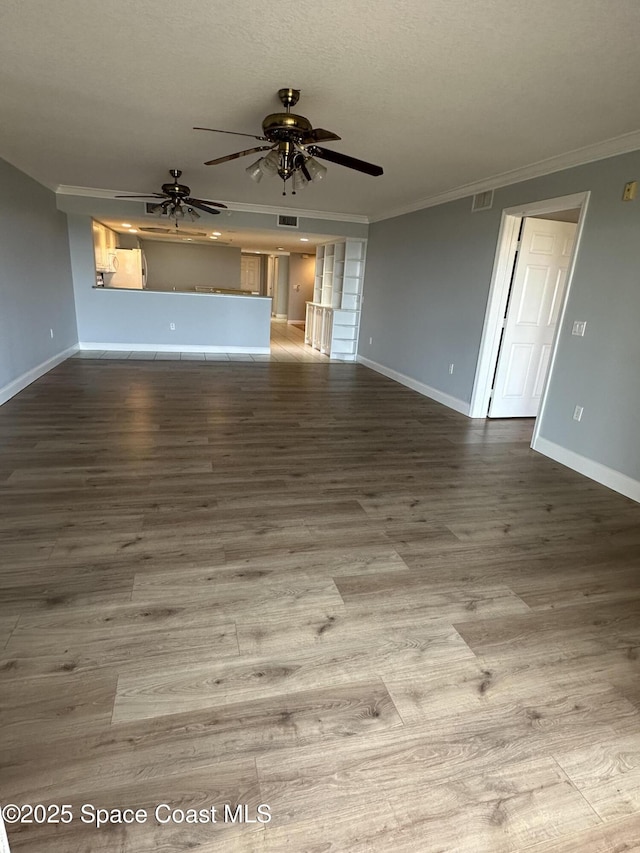 unfurnished living room with hardwood / wood-style floors, crown molding, a textured ceiling, and ceiling fan