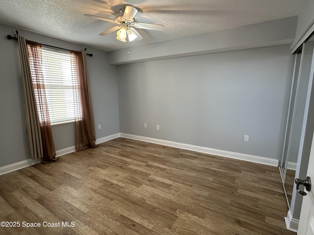 unfurnished bedroom with wood-type flooring, ceiling fan, and a textured ceiling