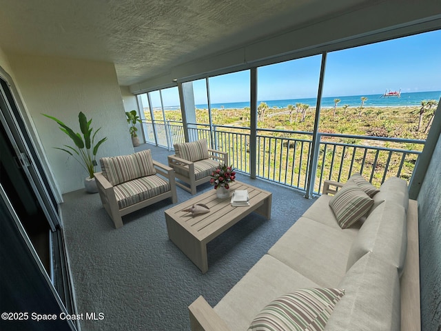 sunroom featuring a water view