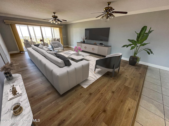 living room with crown molding, ceiling fan, a textured ceiling, and hardwood / wood-style flooring