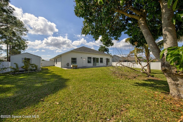 back of house featuring a yard