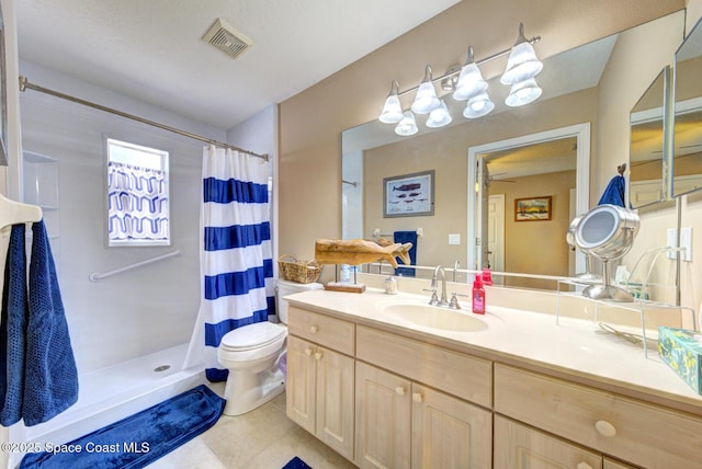 bathroom with tile patterned flooring, vanity, curtained shower, and toilet